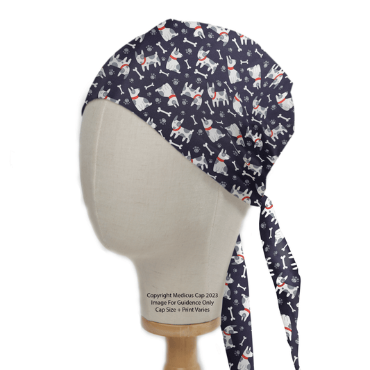 A mannequin head showcases a Boston Terrier Dogs Scrub Cap by Medicus Scrub Caps. Featuring a dark blue design with playful white cartoon cats, the cap integrates a tie-back style and optional custom embroidery, blending charm and personalization in eco-friendly healthcare attire.