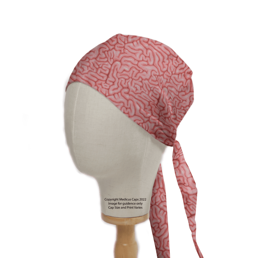 A mannequin head highlights a sustainable healthcare fashion choice with the Brains Pink Human Scrub Cap from Medicus Scrub Caps, featuring brain-like squiggles and a tie-back design. This 2022 copyrighted cap is perfect for stylish, eco-conscious healthcare professionals.