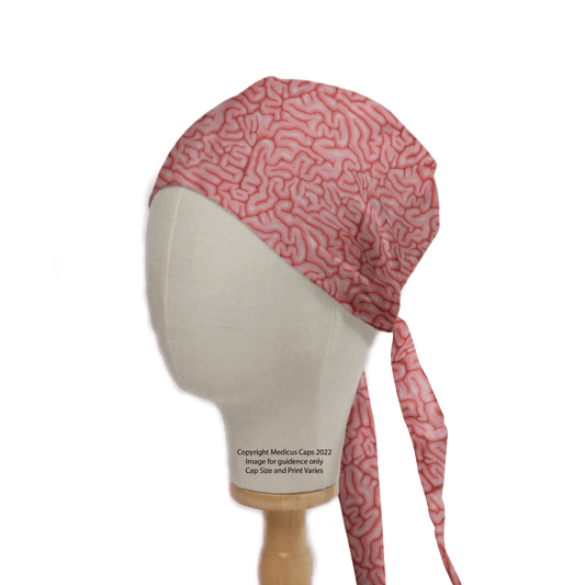 A mannequin head highlights a sustainable healthcare fashion choice with the Brains Pink Human Scrub Cap from Medicus Scrub Caps, featuring brain-like squiggles and a tie-back design. This 2022 copyrighted cap is perfect for stylish, eco-conscious healthcare professionals.