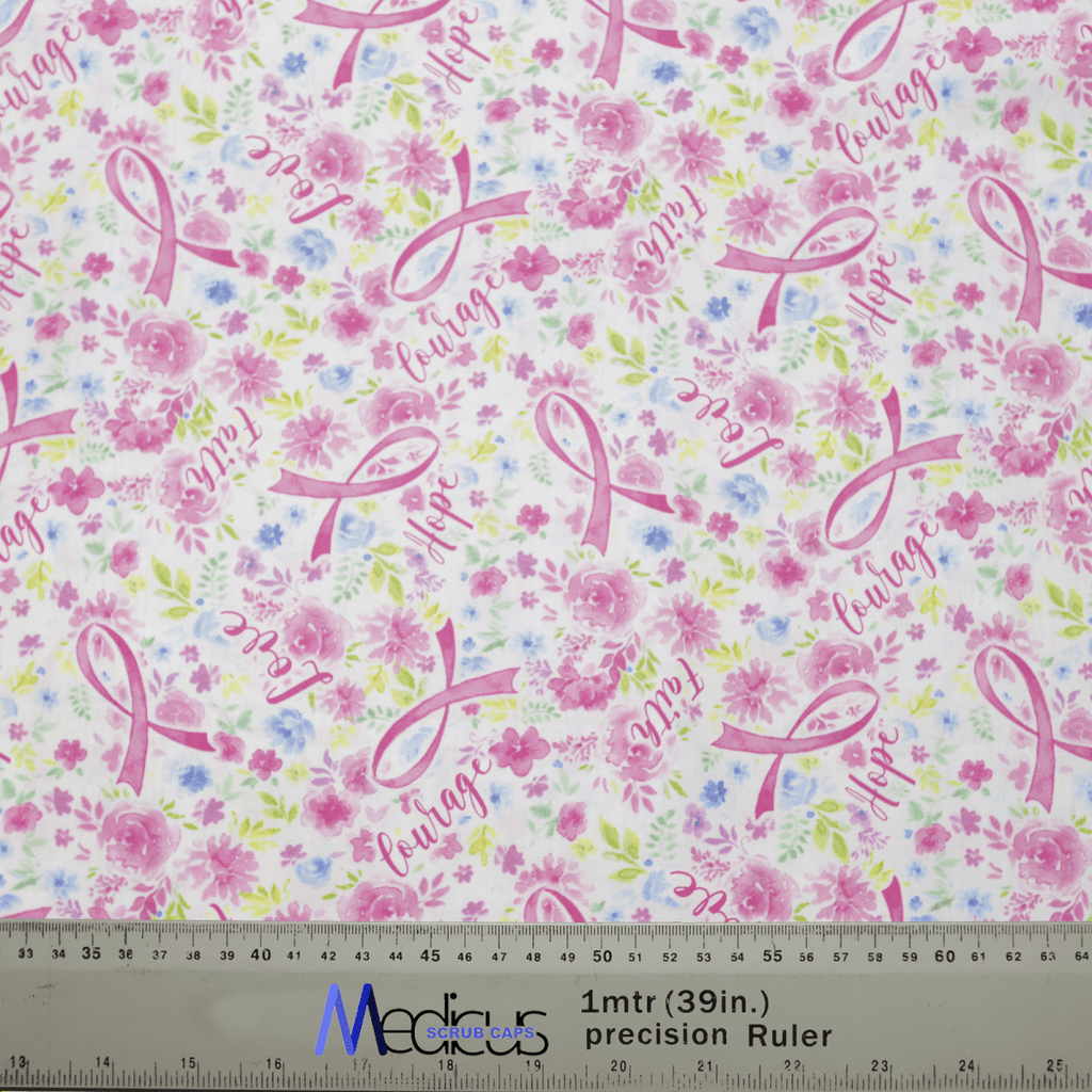The Medicus Scrub Caps Breast Cancer Awareness #1 scrub cap is made from eco-friendly fabric, showcasing pink ribbons, hope and courage in cursive, with delicate pink flowers. It also includes a ruler at the bottom for precise measurements.