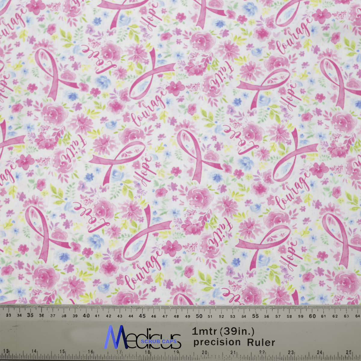 The Medicus Scrub Caps Breast Cancer Awareness #1 scrub cap is made from eco-friendly fabric, showcasing pink ribbons, hope and courage in cursive, with delicate pink flowers. It also includes a ruler at the bottom for precise measurements.