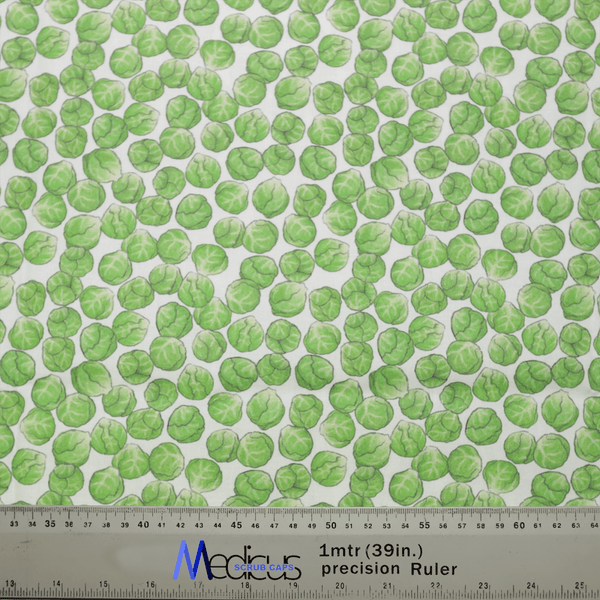 The Medicus Scrub Caps Brussel Sprouts Scrub Cap showcases a chic design with green Brussels sprouts on a light background. A Medoca 1mtr (39in.) precision ruler provides an accurate size reference, ideal for achieving a perfect fit, whether for garments or the scrub cap itself.