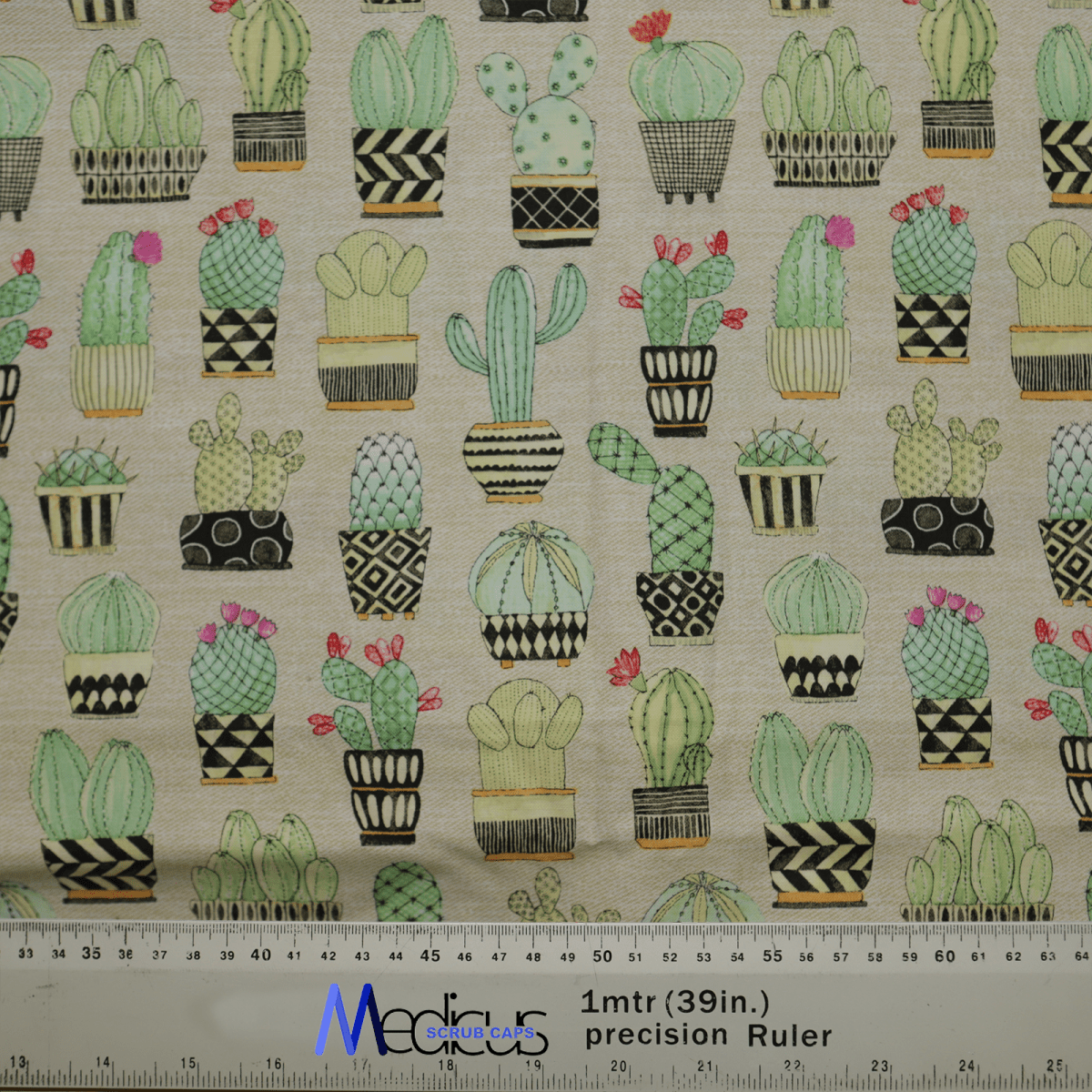 The Cactus #1 Abstract Pots Scrub Cap by Medicus Scrub Caps features patterned fabric with illustrated cacti in decorative pots and black geometric designs. This eco-friendly cap is beige with customizable options, and a scale ruler with manufacturer details is at the bottom.