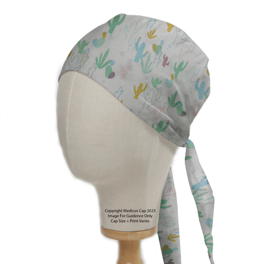 The mannequin head displays the Medicus Scrub Caps eco-friendly Cactus Abstract Desert Scrub Cap, featuring soft green, yellow, and pink cacti on a light background. A copyright notice is included in the design.