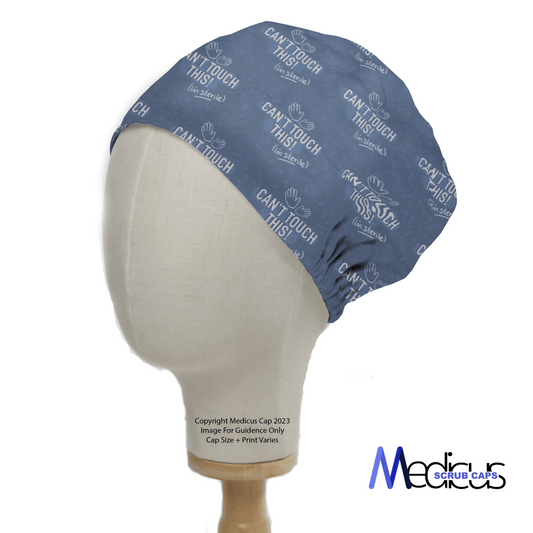 A mannequin head showcases the Cant Touch This Im Sterile Scrub Cap by Medicus Scrub Caps, featuring a blue design with Cant Touch This and hands outline. Fitted for a clean look, it covers most of the head, combining medical style and eco-friendly principles with its logo in the bottom right corner.