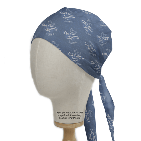 A mannequin head models the Cant Touch This Im Sterile Scrub Cap by Medicus Scrub Caps, featuring a blue design with text. Eco-friendly and tied back, it includes copyright details and size/print notes.