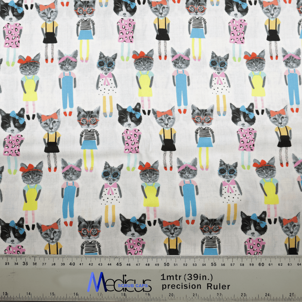 The Cat Cartoon Dress Up Scrub Cap by Medicus Scrub Caps showcases patterned fabric with cartoon cats in colorful outfits, bows, and glasses. Perfect for eco-friendly scrub caps, it includes a 1-meter ruler at the bottom for variety in cat designs.