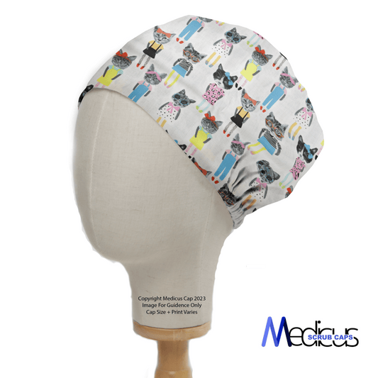 A mannequin displays the eco-friendly Cat Cartoon Dress Up Scrub Cap by Medicus Scrub Caps, featuring cartoon cats in medical outfits. Its snug fit and design are highlighted against a white backdrop, with the Medicus Scrub Caps logo prominently presented to emphasize its authenticity.