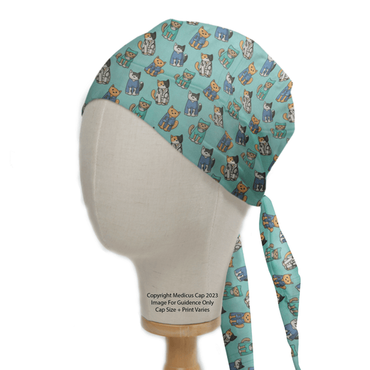 A head mannequin displays the eco-friendly Medicus Scrub Caps Cat Doctor Surgeons Scrub Cap, featuring whimsical cartoon cats. This personalized medical scrub cap, which ties at the back, is perfect for any cat-loving healthcare professional.