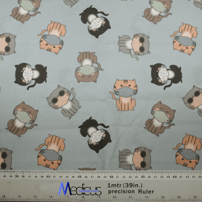 The Cat Face Masks Scrub Cap by Medicus Scrub Caps features a whimsical design of cartoon cats in face masks on a light background, ideal for scrub caps. A ruler is shown nearby for scale.
