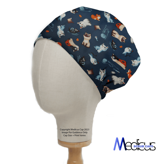 A mannequin head displays the Cats Love Yarn Scrub Cap, featuring cartoon dogs and medical items on a dark background. Made by Medicus Scrub Caps from hypoallergenic cotton, its NHS-compliant and includes copyright info and size variance details.