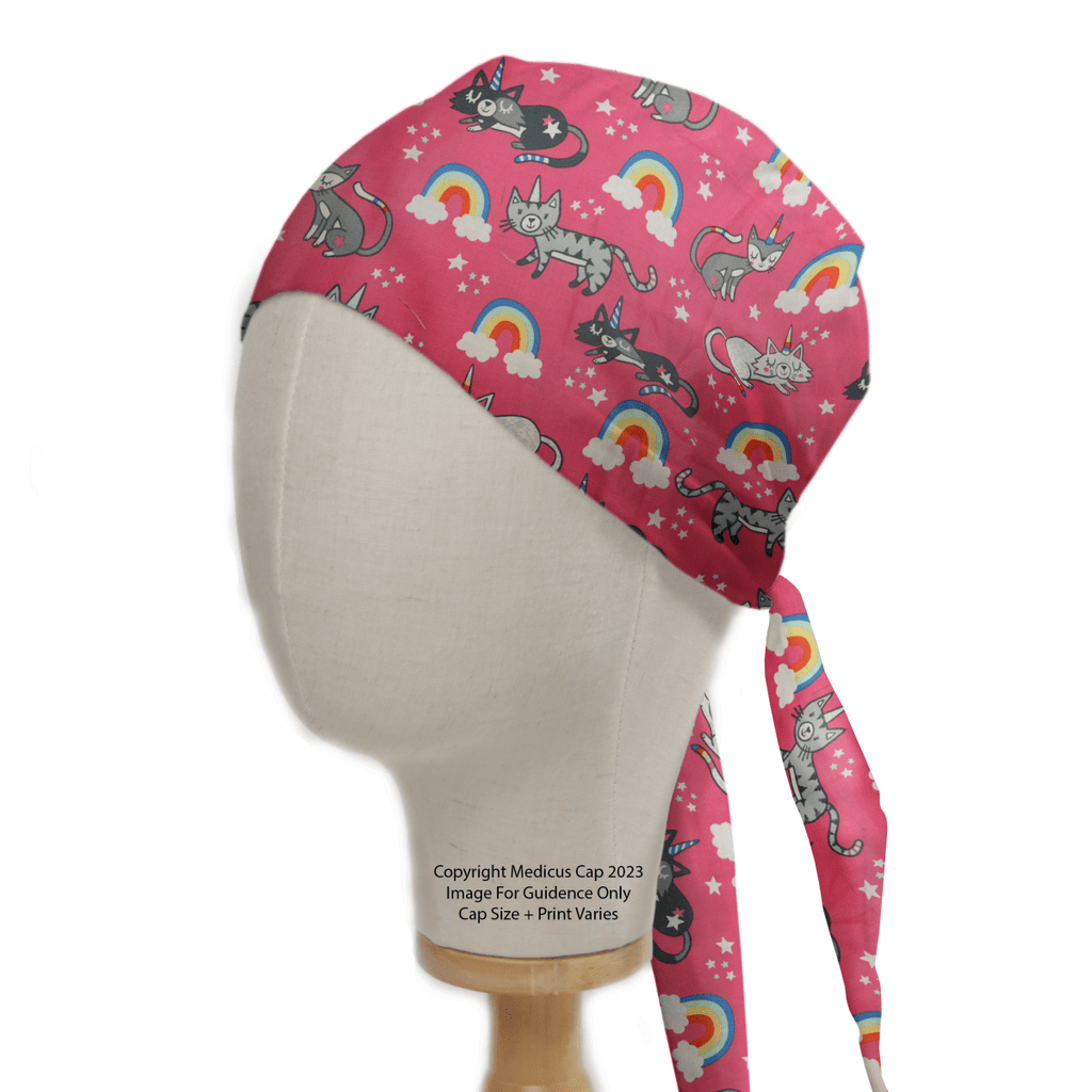 The Medicus Scrub Caps Cats Unicorn Rainbow Pink Scrub Cap, featuring playful gray cats, rainbows, stars, and clouds, is showcased on a mannequin head from the side. It offers comfort and breathability with its back-tie design.