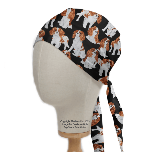 The Cavalier King Charles Spaniels Dogs Scrub Cap by Medicus Scrub Caps is displayed on a mannequin head, featuring intricately detailed Spaniel patterns in brown and white. This black scrub cap, perfect for workwear, ties at the back with visible text at the base of the mannequin.