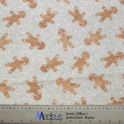 Medicus Scrub Caps offers fabric with smiling gingerbread figures, ideal for a Christmas Gingerbread scrub cap. The light background with small white dots and a ruler in centimeters and inches makes it perfect for creating eco-friendly, customizable scrub caps.