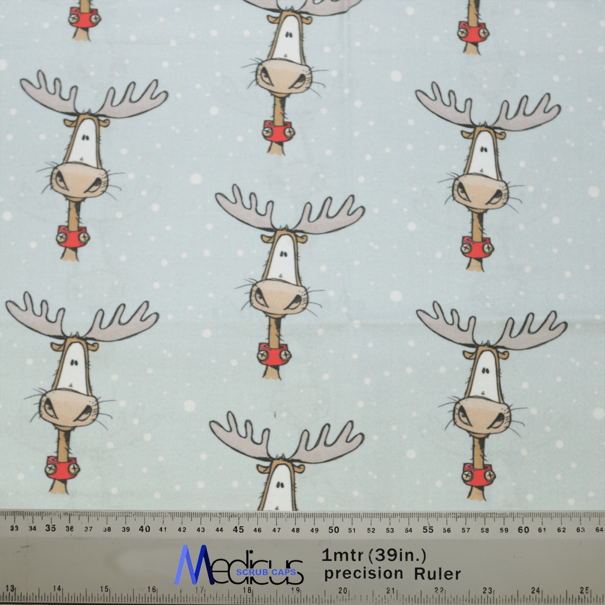 The Christmas Reindeer Big Scrub Cap by Medicus Scrub Caps features festive reindeer in red scarves on a light blue background with white dots, ideal for crafting a cozy scrub cap. A precision ruler at the bottom shows 1mtr (39in.) MCFAB UK for scale.