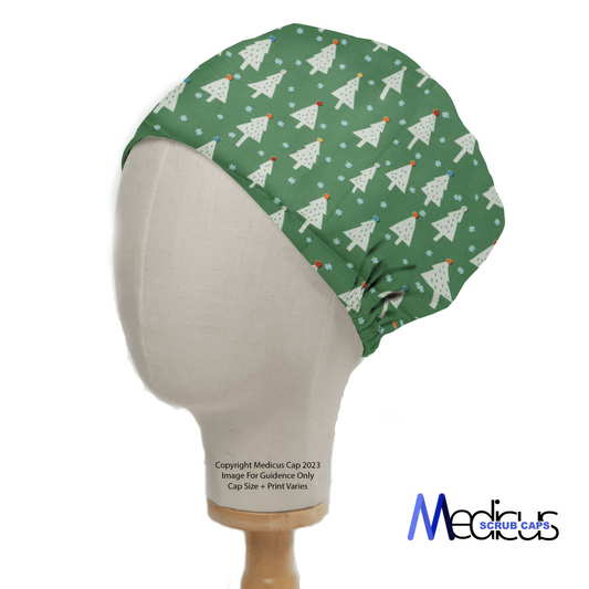 A green scrub cap on a mannequin head displays a festive design featuring white Christmas trees, snowflakes, and red dots. The Medicus Scrub Caps logo is visible at the bottom right. This Christmas Trees Scrub Cap ensures a great fit while providing sustainable savings.