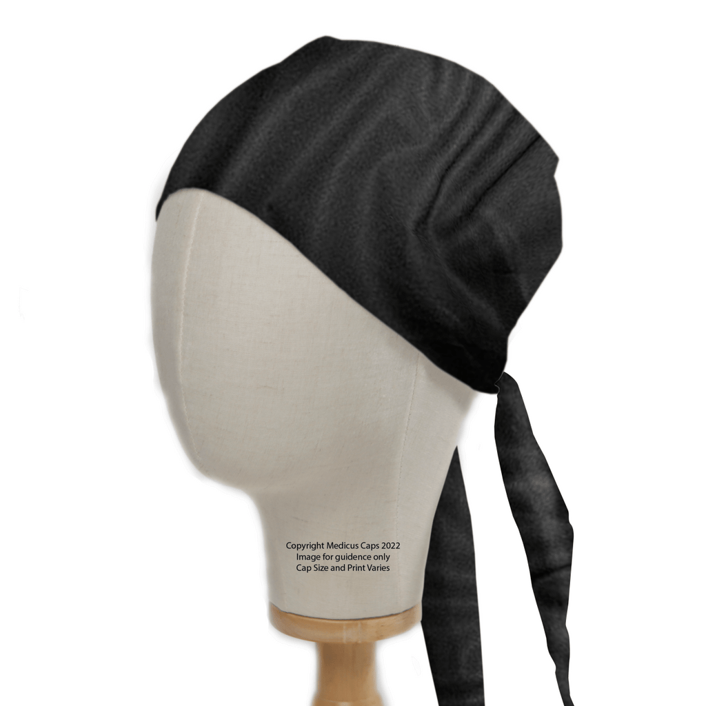 A Classic Plain Black Scrub Cap by Medicus Scrub Caps is showcased on a mannequin head, featuring a smooth texture and back ties with two long straps. Perched on a wooden base, this essential accessory for medical professionals has visible text enhancing its practical appeal.