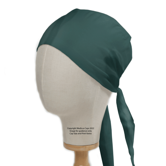 A mannequin head showcases the Medicus Scrub Caps Classic Plain Bottle Green Scrub Cap, made from eco-friendly fabric with quality assurance and long back ties.