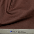 A close-up of soft, sustainable brown fabric draped in folds, paired with a precision ruler showing measurements in cm and inches—perfect for crafting the Classic Plain Brunette Brown Scrub Cap by Medicus Scrub Caps for medical professionals.