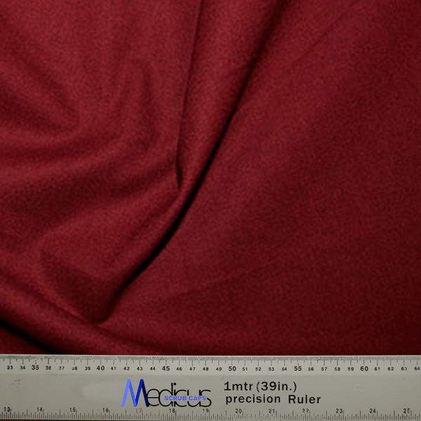 The Classic Plain Claret Red Scrub Cap by Medicus Scrub Caps, resembling durable medical fabric with subtle folds, comes with a Measurement Canada tool at the bottom—perfect for precise needs of medical professionals.
