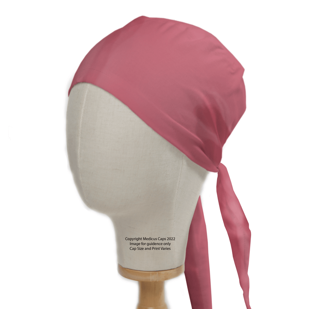 A mannequin head sports the Classic Plain Coral Pink Scrub Cap by Medicus Scrub Caps, which ties at the back. Its smooth sheen ensures a perfect fit and style, completely covering the head while flowing elegantly down the neck to demonstrate its durable design.