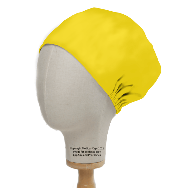 The Classic Plain Corn Yellow Scrub Cap by Medicus Scrub Caps is elegantly fitted on a mannequin head, featuring a gathered back. Its vivid hue contrasts strikingly against the wooden stand, bringing an energetic vibe to the presentation.