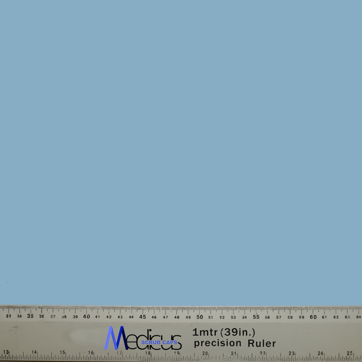 A durable metal ruler, marked in centimeters and inches as 1 mtr (39 in.) precision Ruler, lies horizontally at the bottom of a solid cyan blue background, similar to the Classic Plain Cyan Blue Scrub Cap by Medicus Scrub Caps.