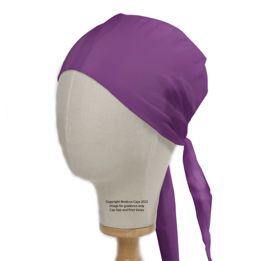 The Medicus Scrub Caps Classic Plain Imperial Purple Scrub Cap, renowned for comfort and durability, is elegantly displayed on a head mannequin. This bandana-style theatre hat features long ties at the back, set against a plain white background.