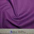 A folded Classic Plain Imperial Purple Scrub Cap by Medicus Scrub Caps is showcased, highlighting its comfort and durability, with a ruler at the bottom showing measurements in centimeters and inches.