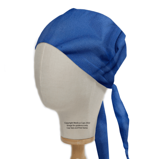 A mannequin head displays the Medicus Scrub Caps Classic Plain Marine Blue Scrub Cap, tied at the back. It features a subtle textured pattern for a professional look, showcased on a wooden stand to highlight its durability.