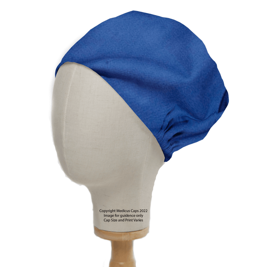 A mannequin head showcases a Medicus Scrub Caps Classic Plain Marine Blue Scrub Cap, offering a professional look with loose-fitting, durable coverage. The cap is elegantly presented on a plain wooden stand.