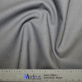 A close-up of the Classic Plain School Grey Scrub Cap fabric by Medicus Scrub Caps showcases a swirling pattern, perfect for crafting durable scrub caps. Below is a precision ruler measuring 1 meter or 39 inches, featuring both centimeters and inches for healthcare professionals precise cutting needs.