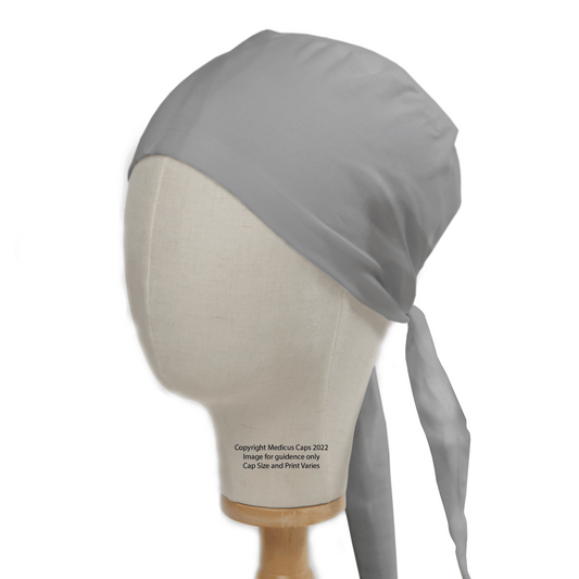 A mannequin head displays the Classic Plain School Grey Scrub Cap by Medicus Scrub Caps, featuring a simple, durable design. Its tied at the back and covers the entire head, ideal for healthcare professionals. Set against a white background, it blends practicality and style in medical wear.