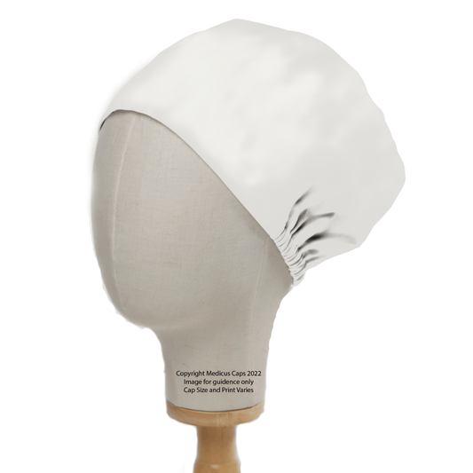 A Medicus Scrub Caps Classic Plain White Scrub Cap, resembling a theatre hat, is smoothly fitted on a mannequin head with a subtle sheen. The mannequin is elegantly displayed on a wooden stand.