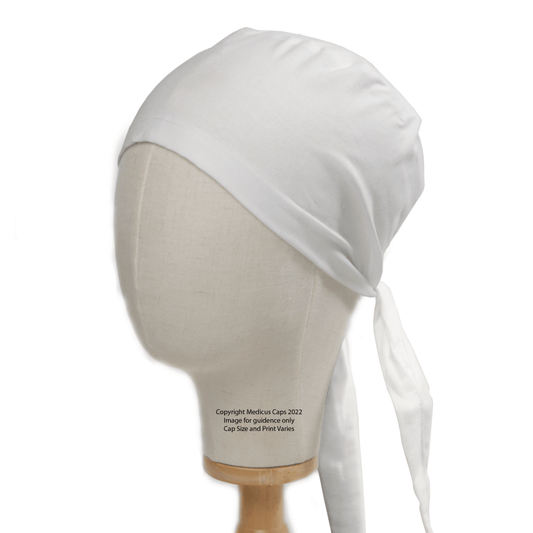 Shown on a mannequin head, the Classic Plain White Scrub Cap by Medicus Scrub Caps is a versatile cap. Made from 100% cotton for smooth texture, it ties at the back with long ends and covers the entire scalp. Perfect as a theatre hat or everyday accessory.