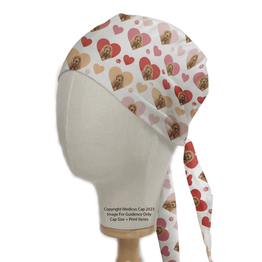 A mannequin displays a Cocker Spaniel Dogs Hearts White Scrub Cap by Medicus Scrub Caps, featuring heart and Cocker Spaniel patterns in pink, cream, and red against a plain background, blending style with charm.