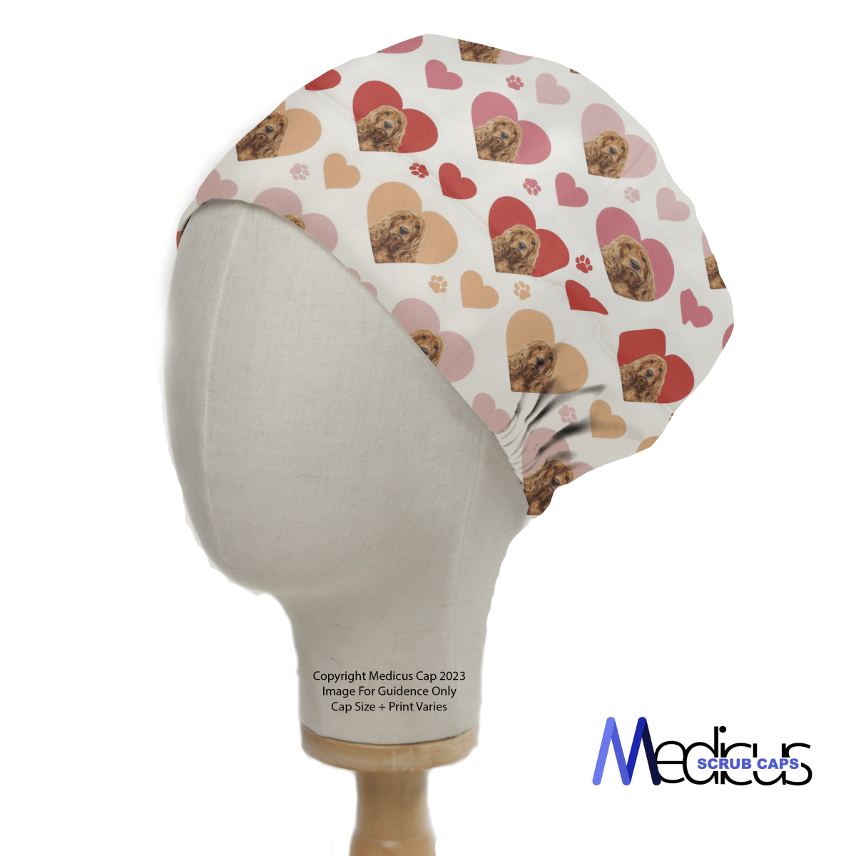 The Cocker Spaniel Dogs Hearts White Scrub Cap by Medicus Scrub Caps, perfect for healthcare professionals, is showcased on a mannequin. It features a playful red and pink heart design with dogs, including a Cocker Spaniel, on a light background and reads Copyright Medicus Cap 2023.