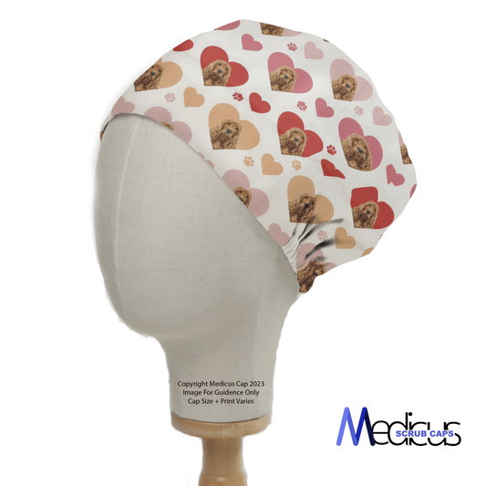 The Cocker Spaniel Dogs Hearts White Scrub Cap by Medicus Scrub Caps, perfect for healthcare professionals, is showcased on a mannequin. It features a playful red and pink heart design with dogs, including a Cocker Spaniel, on a light background and reads Copyright Medicus Cap 2023.