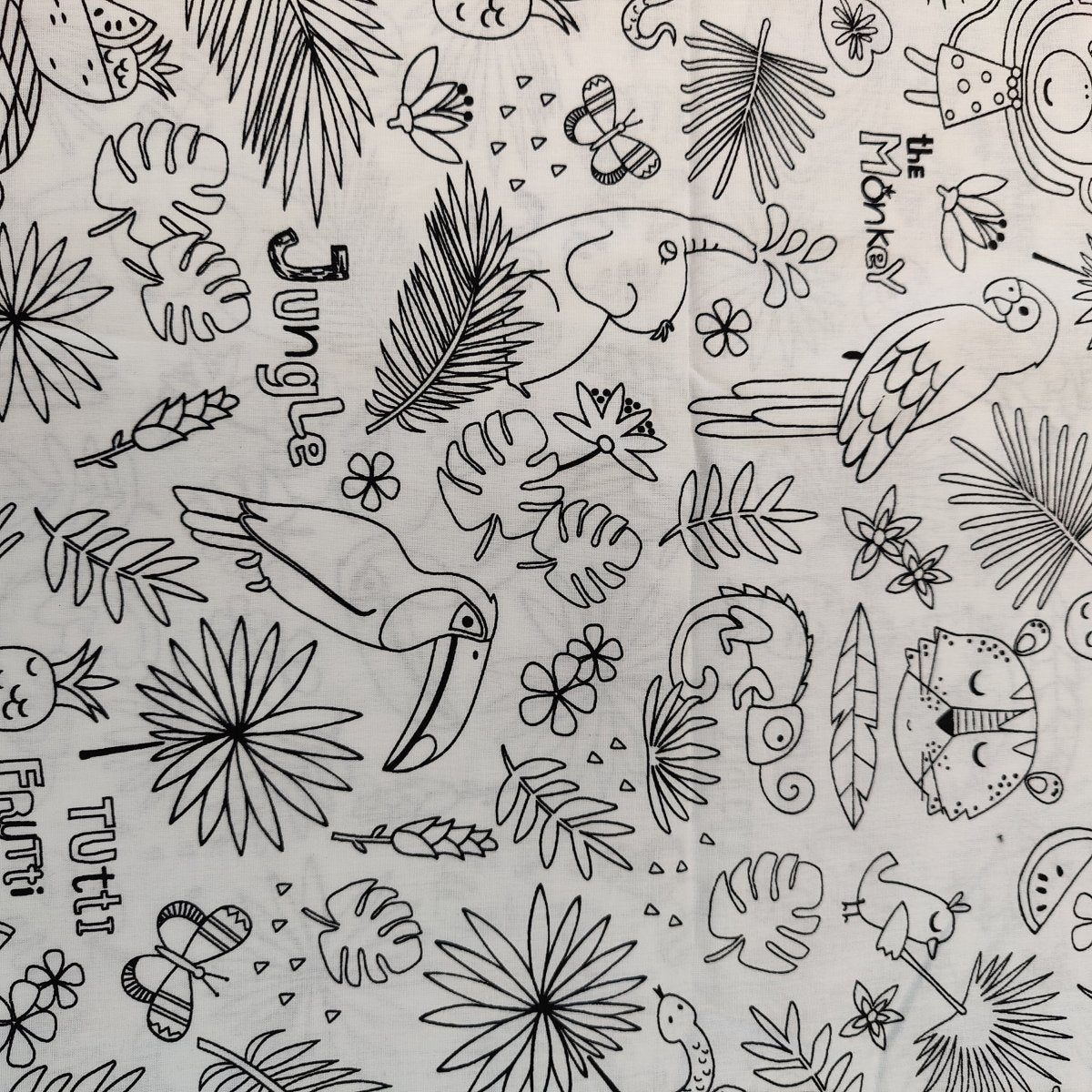 The Colour Me In Scrub Cap by Medicus Scrub Caps showcases black and white line art of toucans, monkeys, tigers, parrots, and lush foliage with the words Jungle, Tutti Frutti, and The Monkey scattered throughout for a hygienic yet stylish look.