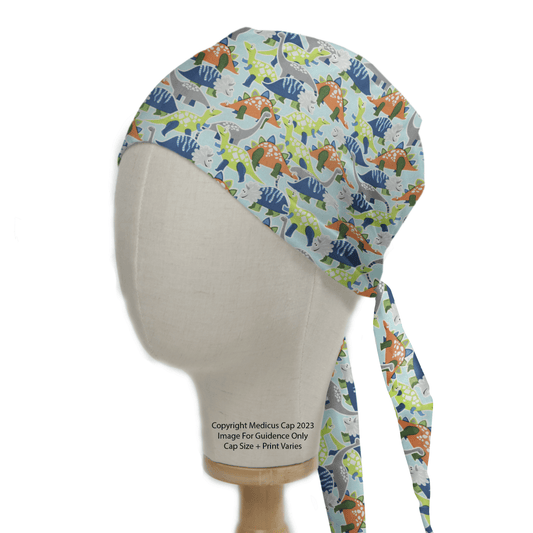 Displayed on a mannequin, the Medicus Scrub Caps Colourful Dinosaurs Scrub Cap shows off blue, green, and orange dinosaurs on a light background. With an easy-to-tie back, it adds a playful touch to your medical attire.