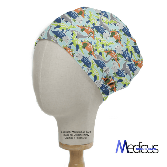 The Colourful Dinosaurs Scrub Cap from Medicus Scrub Caps displays vibrant blue, green, orange, and gray dinosaur prints on a light background. Elegantly modeled on a mannequin, it proudly features the logo in the bottom right corner.