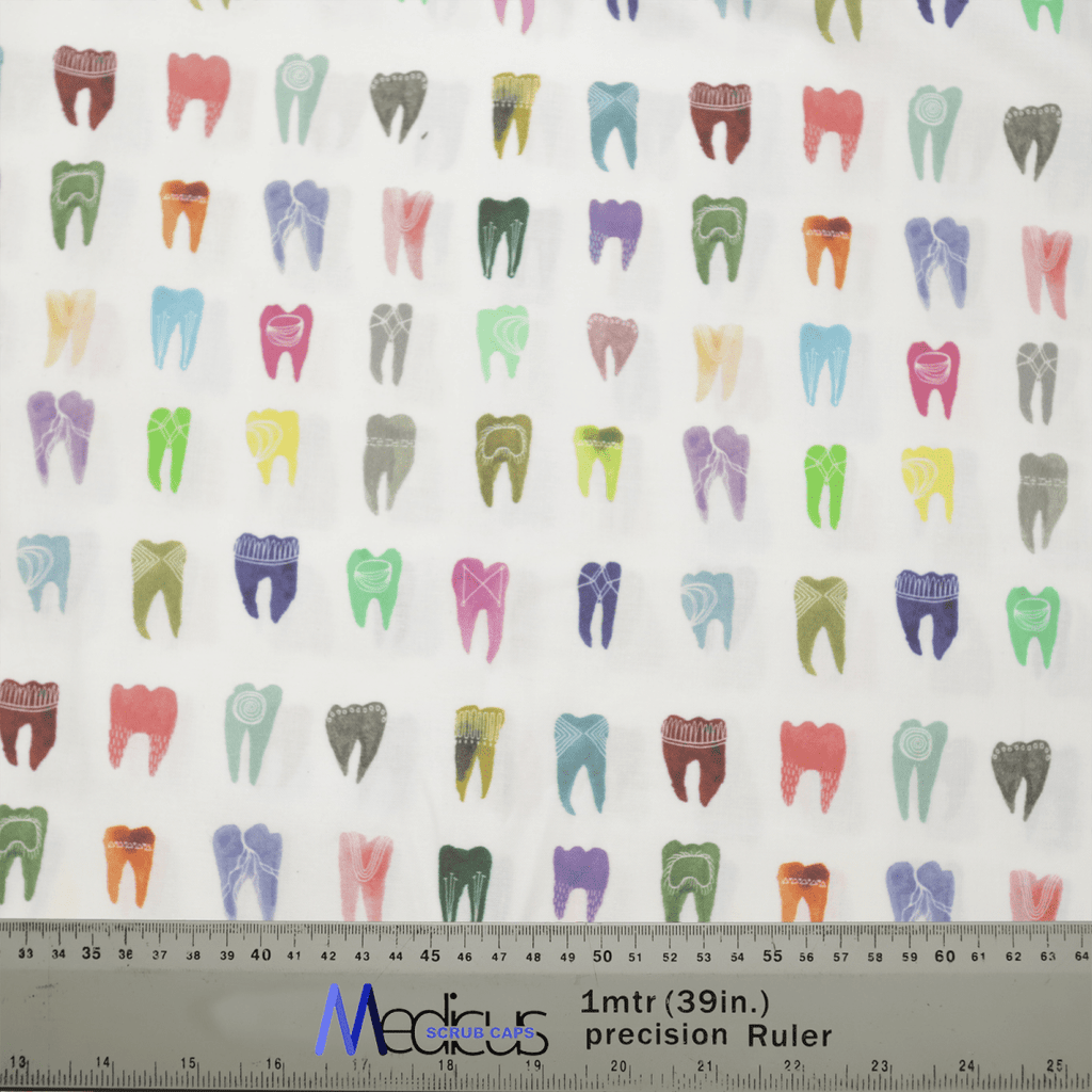 Featuring a vibrant pattern of illustrated teeth in various shades on white fabric, the Medicus Scrub Caps Colourful Tooth Dentist Scrub Cap is ideal for dental professionals. A ruler with inches and centimeters indicates scale at the bottom.