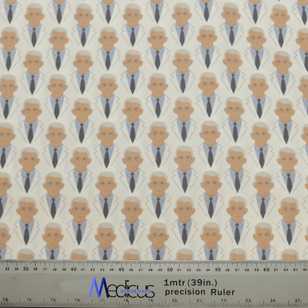The Covid Dr Facci Doctor Scrub Cap by Medicus Scrub Caps features a repeating pattern of a professional-looking figure in a white coat. Ruler provides scale.