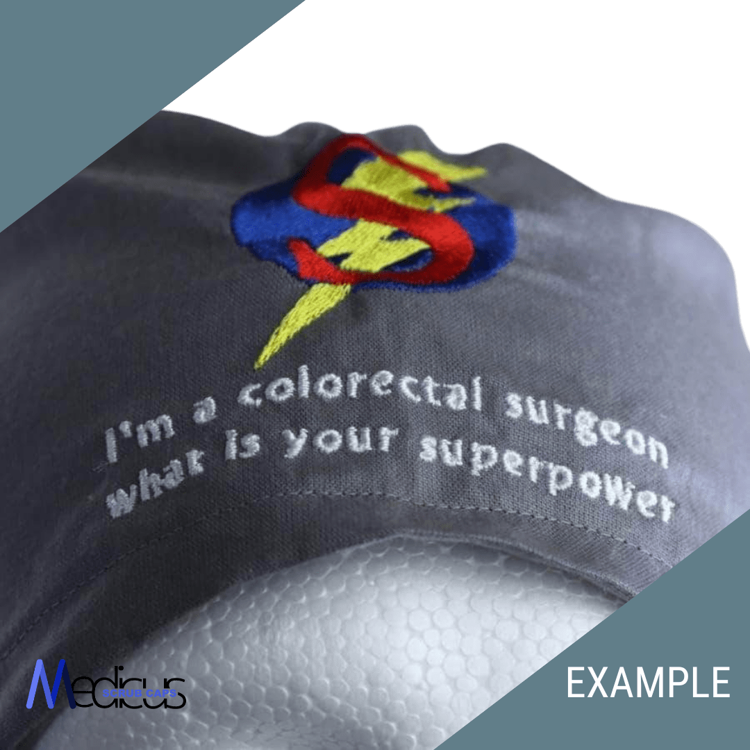 A custom gray scrub cap made from high-quality fabric by Medicus Scrub Caps displays an embroidered stylized ‘S’ with a lightning bolt and the text, Im a colorectal surgeon, what is your superpower? The cap is personalized with the “Medicus” logo and “EXAMPLE” in the corner.