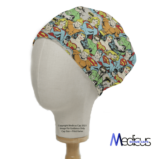 A mannequin head wears the DC Character Crowd Colourful Scrub Cap by Medicus Scrub Caps, featuring vibrant superhero illustrations on a patterned fabric.