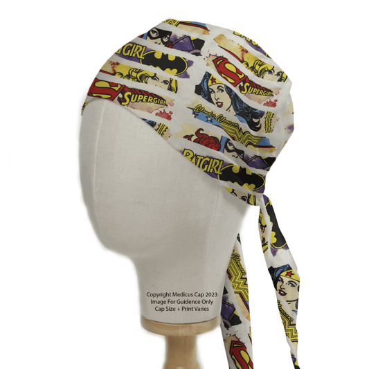 Side view of a mannequin head wearing a Medicus Scrub Caps DC Comic Superhero Women Comic Strip Scrub Cap, featuring vibrant designs of Supergirl and Batgirl with colorful illustrations and iconic logos.