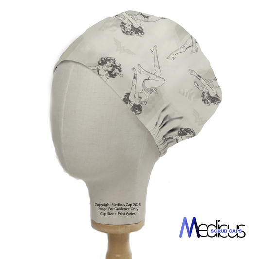 A fabric mannequin head displays the Dc Comic Wonder Woman Light Grey Monochrome Scrub Cap from Medicus Scrub Caps. This off-white cap with black, vintage comic-style Wonder Woman illustrations is perfect for healthcare professionals and features the brands logo on the bottom right.