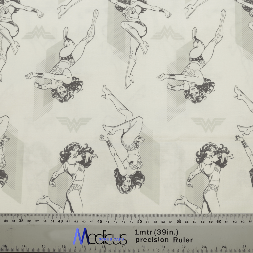 The DC Comic Wonder Woman Light Grey Monochrome Scrub Cap by Medicus Scrub Caps features patterned fabric with illustrated superhero poses. The light grey background highlights the star motifs, and a ruler at the bottom adds scale, ideal for healthcare professionals wanting a heroic look.