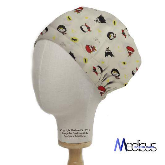 A mannequin head displays the DC Kawaii | Batman | Wonder Woman On White Scrub Cap, ideal for healthcare professionals. Decorated with cute characters on a light background, it features a copyright notice on the base and the Medicus Scrub Caps logo in the bottom right.