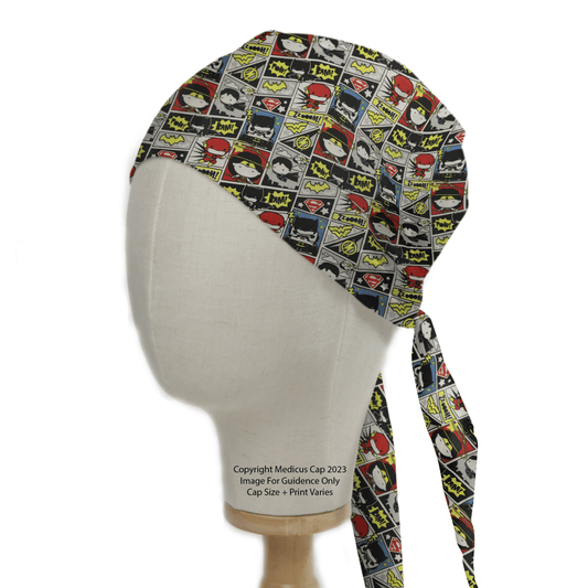 The Medicus Scrub Caps DC Kawaii Comic Strip scrub cap, shown on a mannequin head, dazzles with vibrant superhero logos and Pow and Zap sound effects. Ideal for healthcare professionals, it features a tie-back design that adds flair to daily duties.